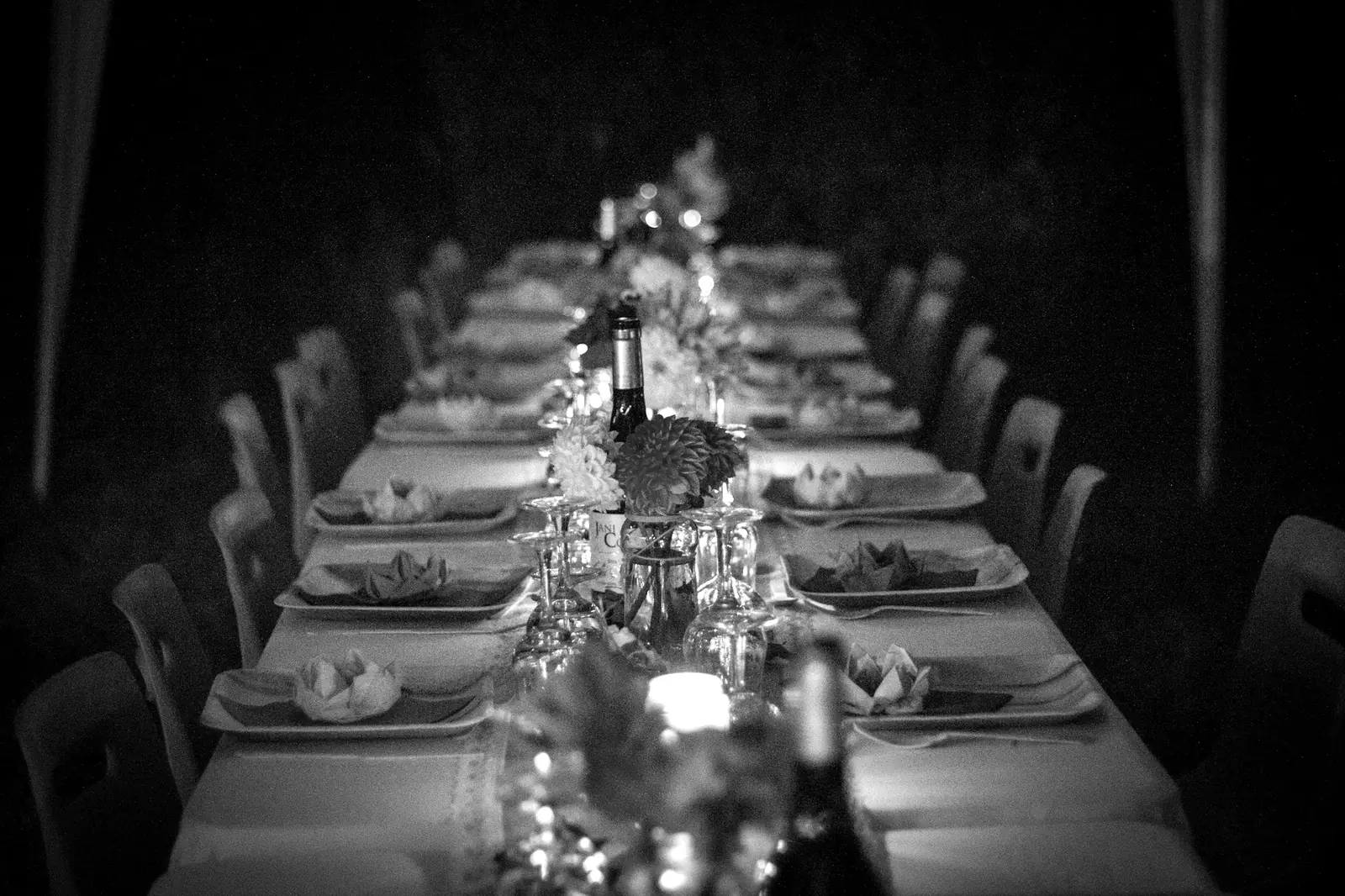 Une longue table de dîner de gala, bougies et verres